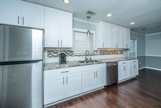 kitchen with white cabinets, sink, stainless steel appliances, and dark hardwood / wood-style flooring