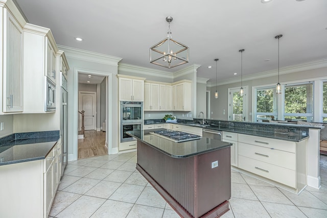 kitchen featuring light tile patterned flooring, appliances with stainless steel finishes, decorative light fixtures, and a kitchen island