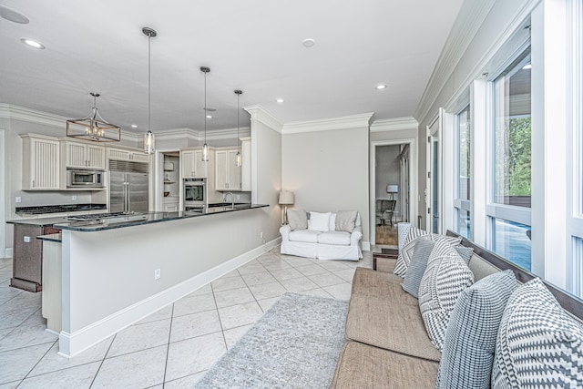 kitchen featuring built in appliances, crown molding, kitchen peninsula, and hanging light fixtures