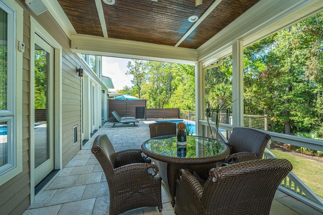 sunroom / solarium featuring wood ceiling