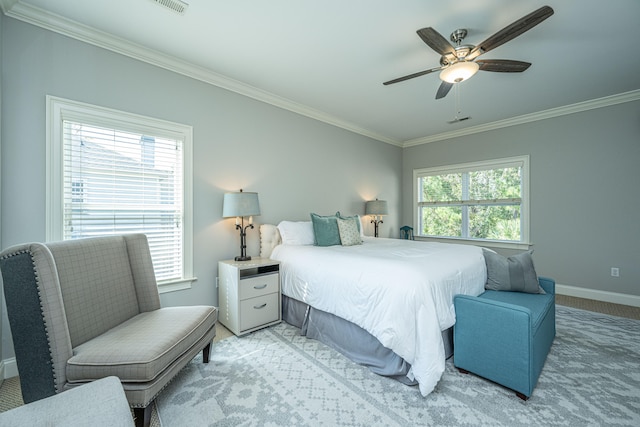 carpeted bedroom with ceiling fan, ornamental molding, and multiple windows