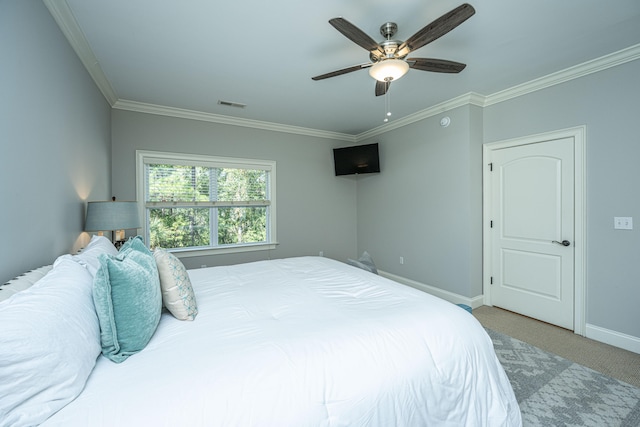 carpeted bedroom featuring ceiling fan and crown molding