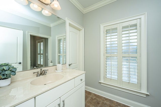 bathroom with vanity, a healthy amount of sunlight, ornamental molding, and tile patterned flooring