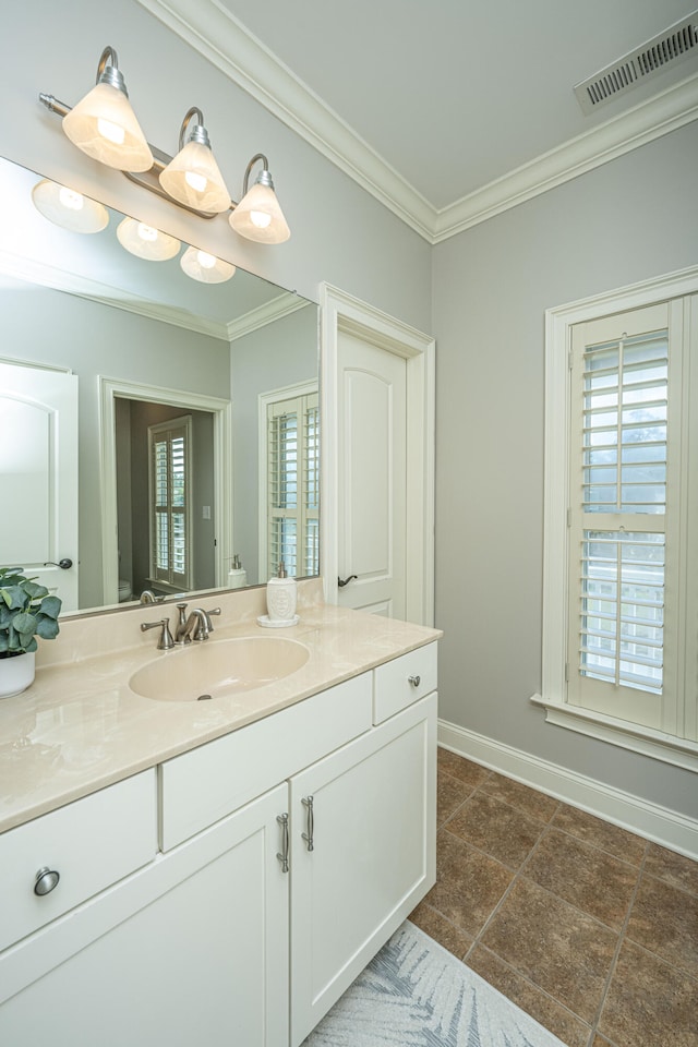 bathroom with vanity, crown molding, and a healthy amount of sunlight