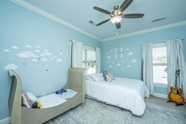 carpeted bedroom featuring crown molding and ceiling fan