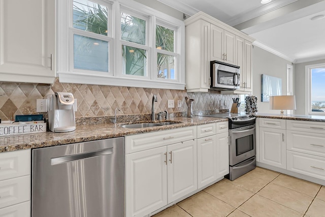 kitchen with a sink, ornamental molding, backsplash, and stainless steel appliances