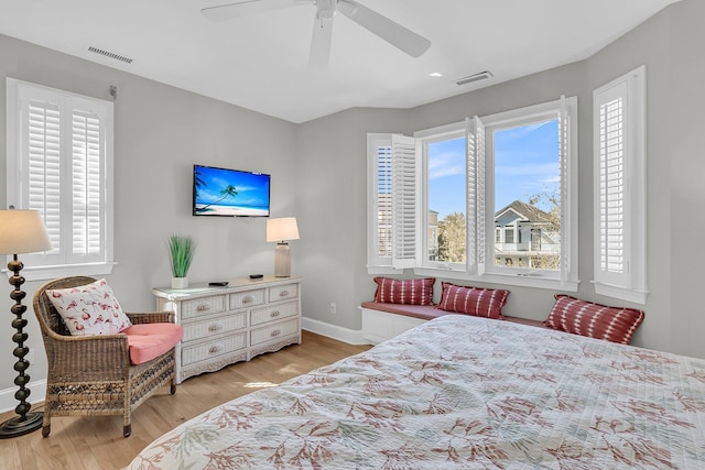 bedroom featuring visible vents, baseboards, a ceiling fan, and light wood finished floors