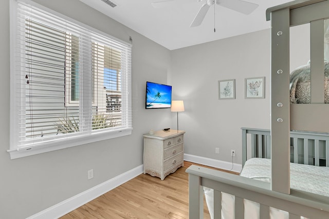 bedroom with visible vents, baseboards, light wood-style floors, and a ceiling fan