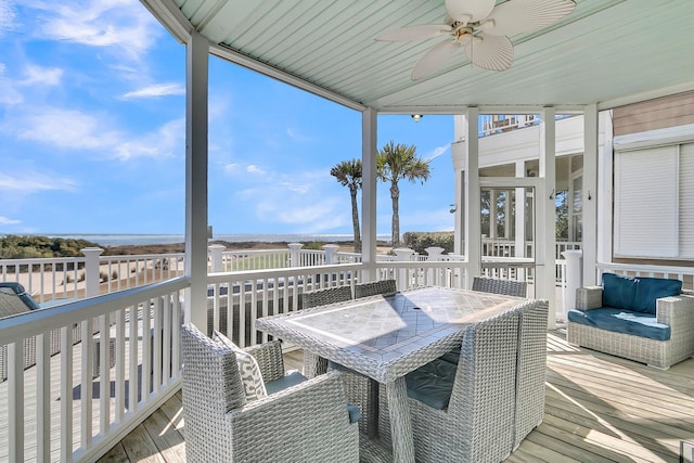 deck featuring outdoor dining area and ceiling fan