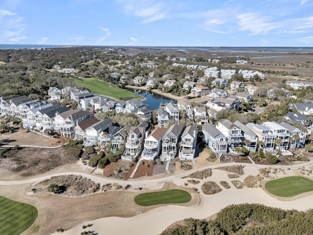 drone / aerial view with a residential view, a water view, and view of golf course