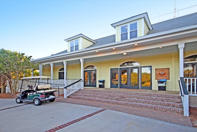 view of front of property with a porch and french doors