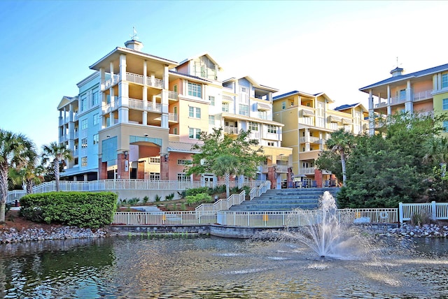 view of property with a water view and fence