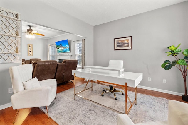 home office featuring hardwood / wood-style floors and ceiling fan