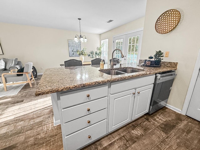 kitchen with dishwasher, sink, dark hardwood / wood-style floors, a notable chandelier, and white cabinets