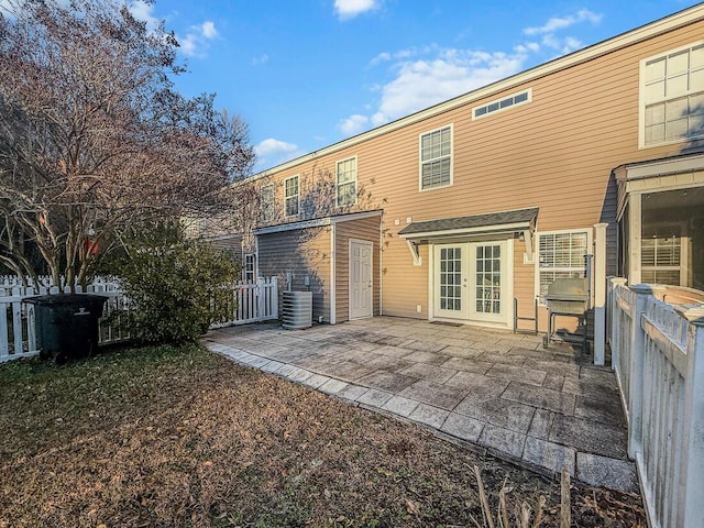 rear view of house with a patio area and french doors