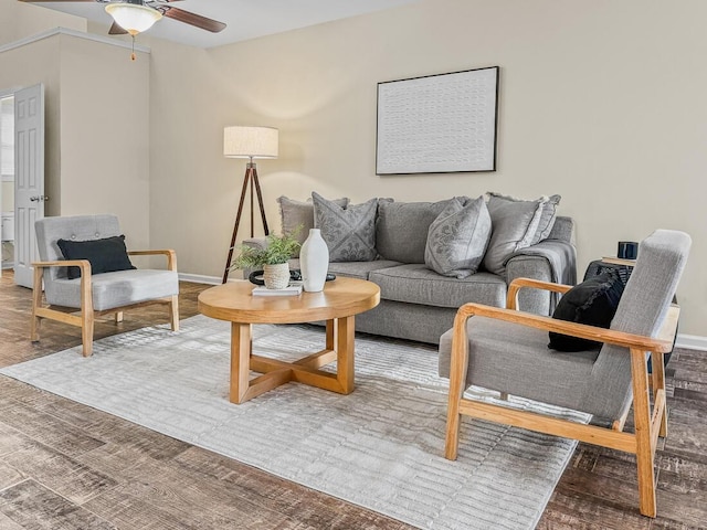 living room featuring wood-type flooring and ceiling fan