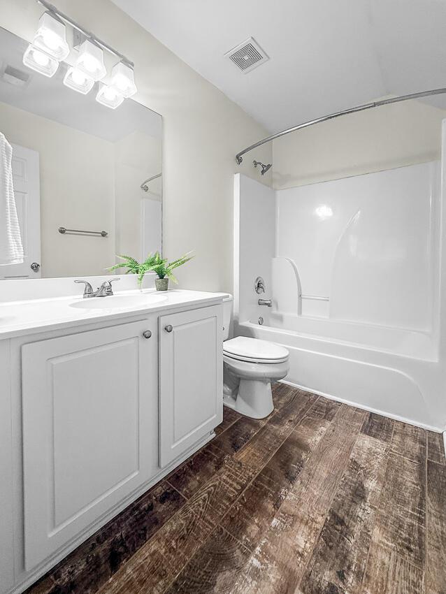 full bathroom featuring vanity, shower / bathtub combination, and toilet