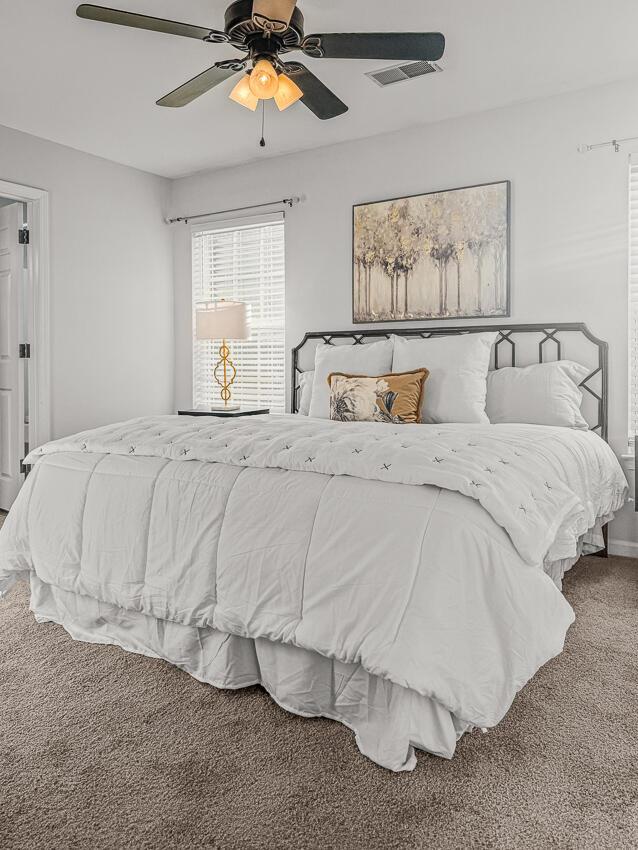 bedroom featuring ceiling fan and carpet floors