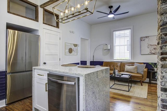 kitchen featuring pendant lighting, wine cooler, dark hardwood / wood-style flooring, stainless steel refrigerator, and white cabinets