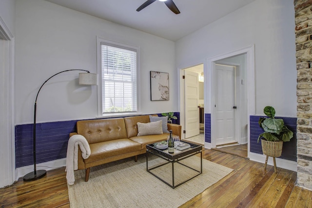 living room with ceiling fan and dark hardwood / wood-style flooring