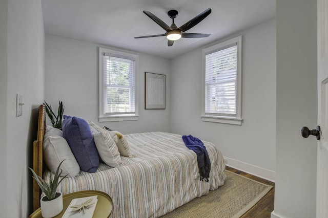 bedroom featuring ceiling fan and dark wood-type flooring