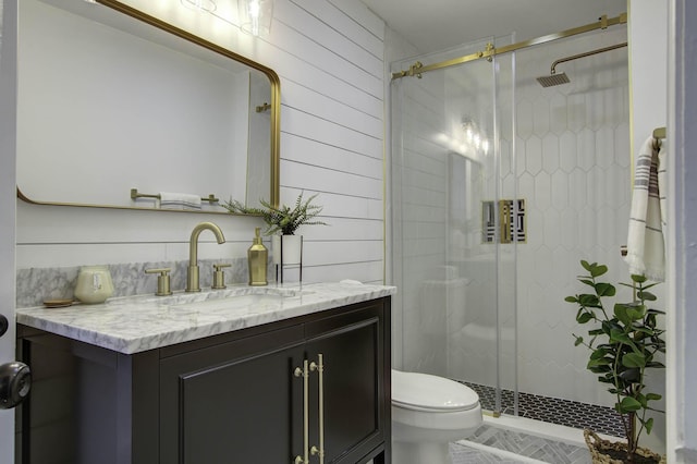 bathroom featuring walk in shower, wooden walls, vanity, and toilet