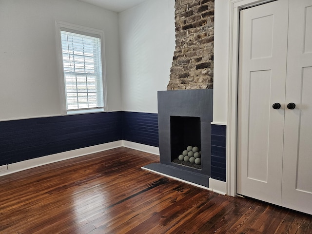 unfurnished living room featuring dark wood-type flooring