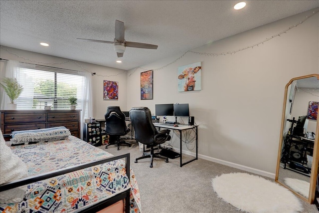 carpeted bedroom featuring ceiling fan and a textured ceiling