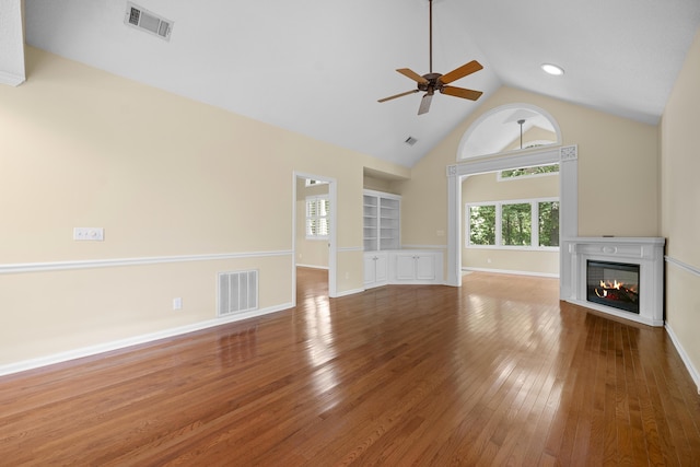 9175 Spring Branch Ct, North Charleston, SC 29406 - unfurnished living room with a glass covered fireplace, ceiling fan, hardwood / wood-style floors, built in features, and high vaulted ceiling