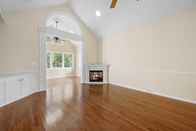 9175 Spring Branch Ct, North Charleston, SC 29406 - unfurnished living room featuring ceiling fan, a glass covered fireplace, wood finished floors, and high vaulted ceiling