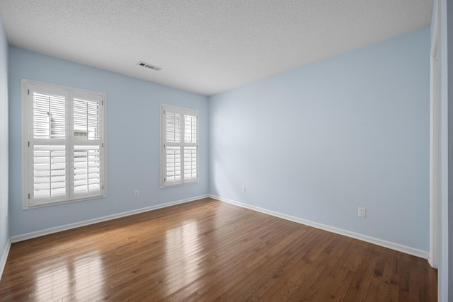 9175 Spring Branch Ct, North Charleston, SC 29406 - spare room with dark wood-type flooring and a textured ceiling
