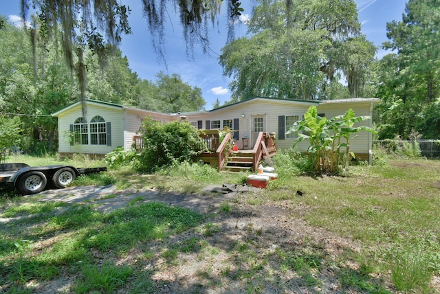 rear view of property featuring a deck