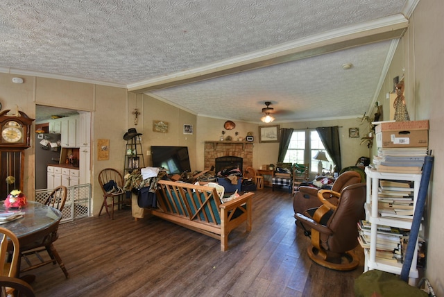 living room with crown molding, a fireplace, ceiling fan, and wood finished floors