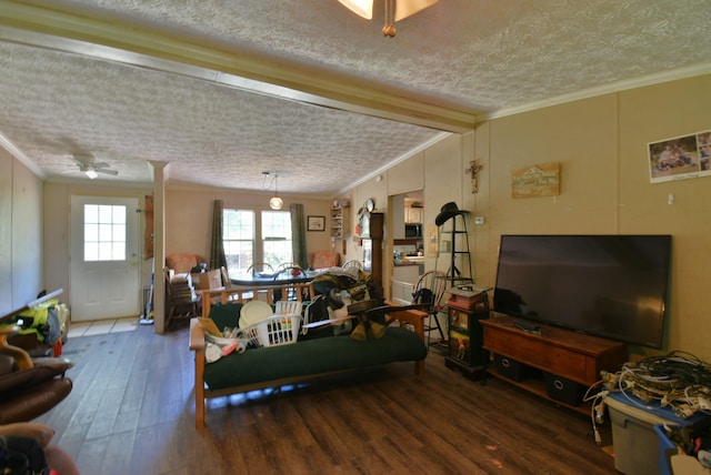 living room featuring a ceiling fan, a textured ceiling, ornamental molding, and wood finished floors