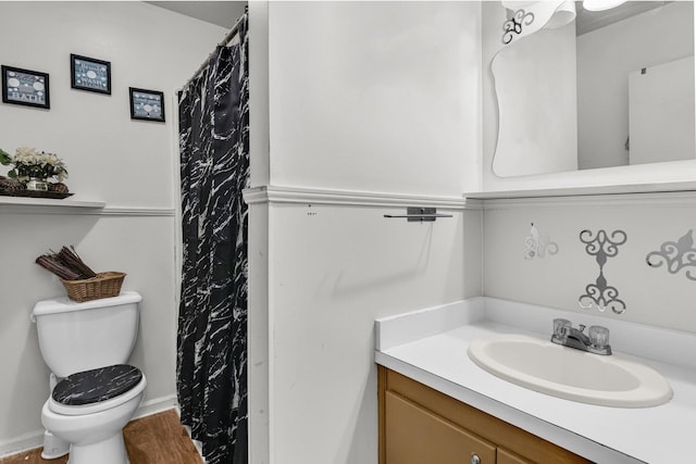 bathroom featuring vanity, hardwood / wood-style flooring, and toilet