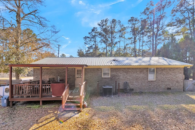 rear view of house with central AC unit and a deck