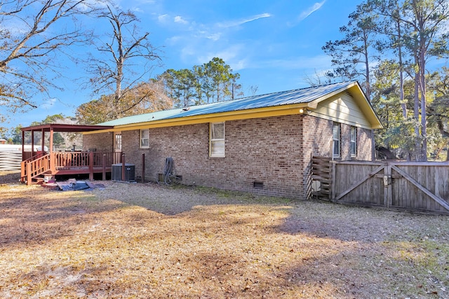 rear view of property with central AC and a deck