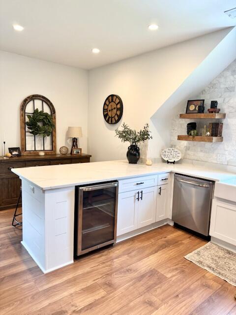 indoor dry bar featuring dishwasher, beverage cooler, light wood-style floors, and recessed lighting
