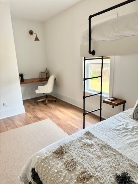 bedroom featuring wood finished floors and baseboards