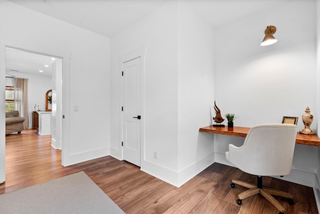 home office with wood finished floors and baseboards