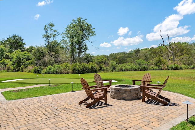 view of patio featuring a fire pit and a putting area