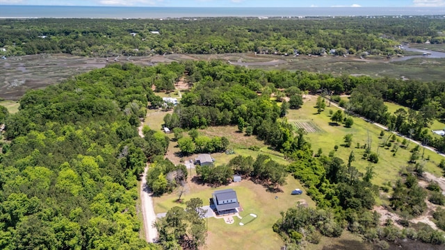 view of property location with a forest