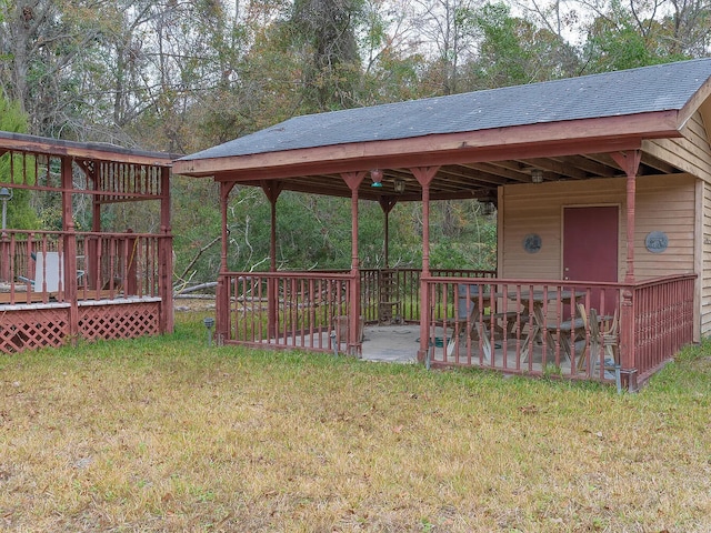 view of yard with a wooden deck and a patio