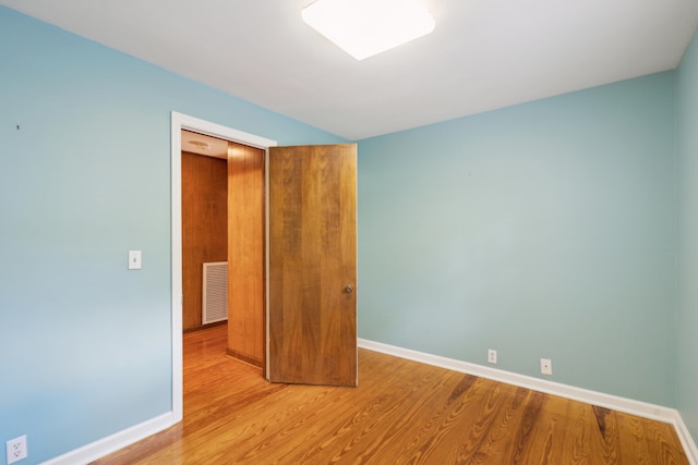 empty room with wood-type flooring