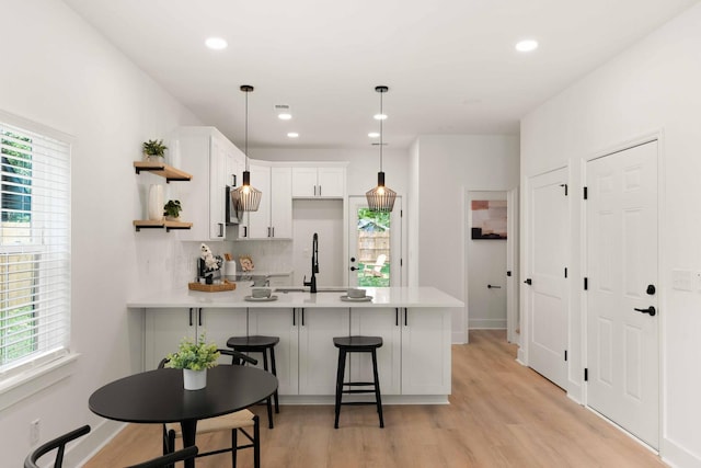 866 Tripe St, Charleston, SC 29407 - kitchen with open shelves, a peninsula, a sink, light countertops, and recessed lighting