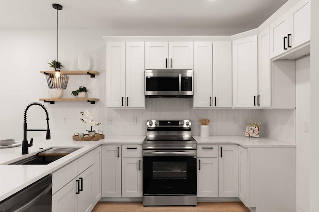 866 Tripe St, Charleston, SC 29407 - kitchen featuring stainless steel appliances, a sink, light countertops, white cabinets, and backsplash