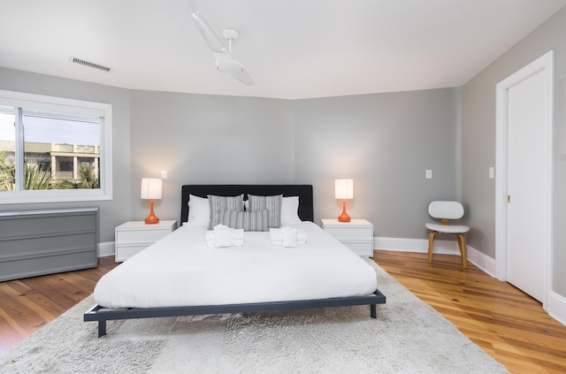 bedroom featuring baseboards, visible vents, and light wood-style floors