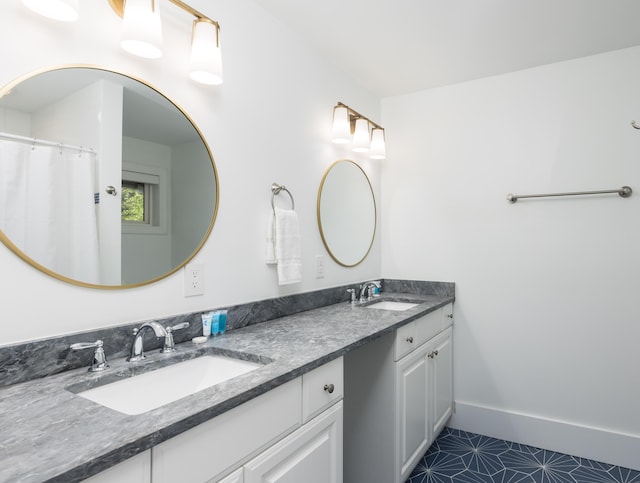 full bathroom featuring a sink, double vanity, and tile patterned flooring