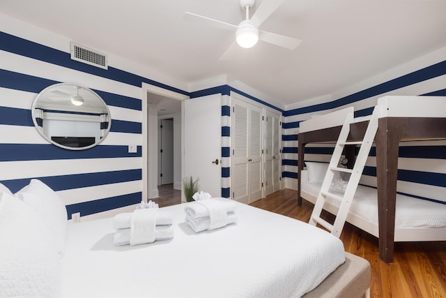 bedroom featuring visible vents, wood finished floors, and ceiling fan