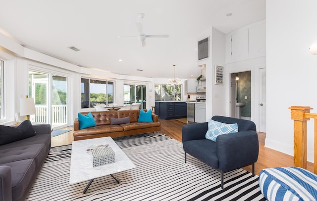 living area featuring a ceiling fan, light wood-style flooring, recessed lighting, baseboards, and visible vents
